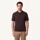 Model wearing rizvol alba cotton silk polo shirt in auburn