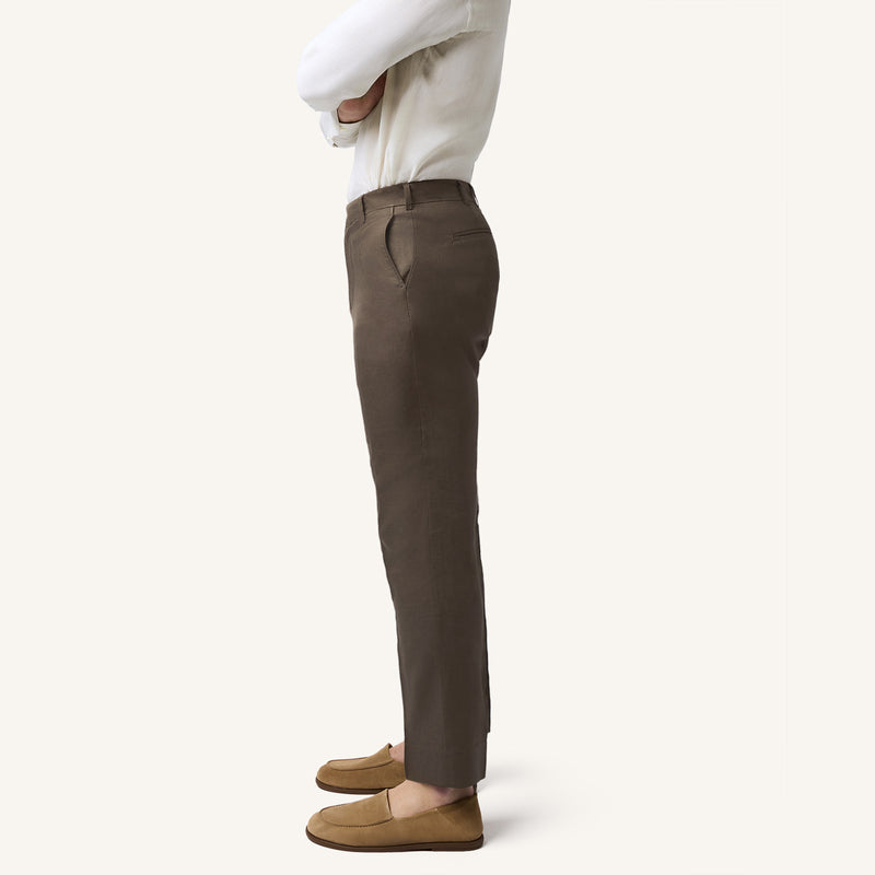 Model wearing Rizvol Dried Fig brown Italian linen trousers, side view