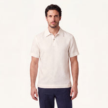 Model wearing Rizvol linen polo shirt in ivory ash 