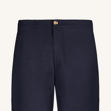 Navy blue pants with a button on a light gray background