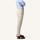 Model wearing Rizvol salt beige linen trousers side view
