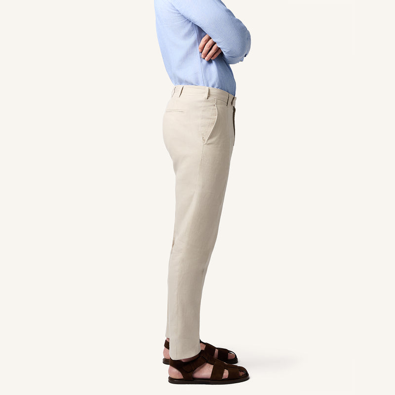 Model wearing Rizvol salt beige linen trousers side view