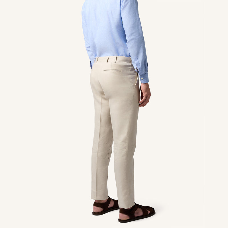 Model wearing Rizvol salt beige linen trousers back view